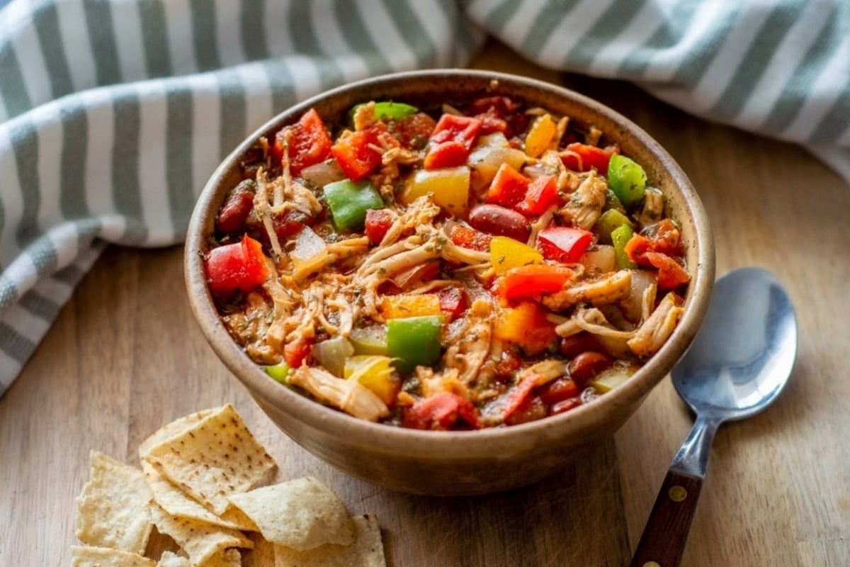 Chicken fajitas in a bowl with tortilla chips, perfect for a quick and easy chicken soup recipe.