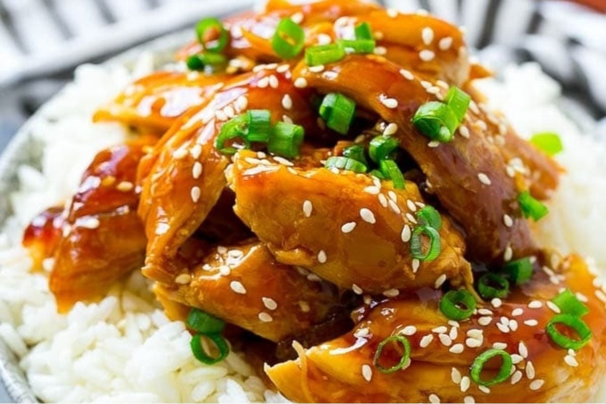 Wholesome Asian chicken on top of rice with sesame seeds.