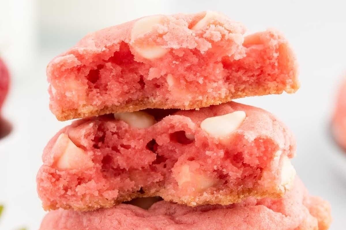 Pink strawberry white chocolate cookies stacked on top of each other.
