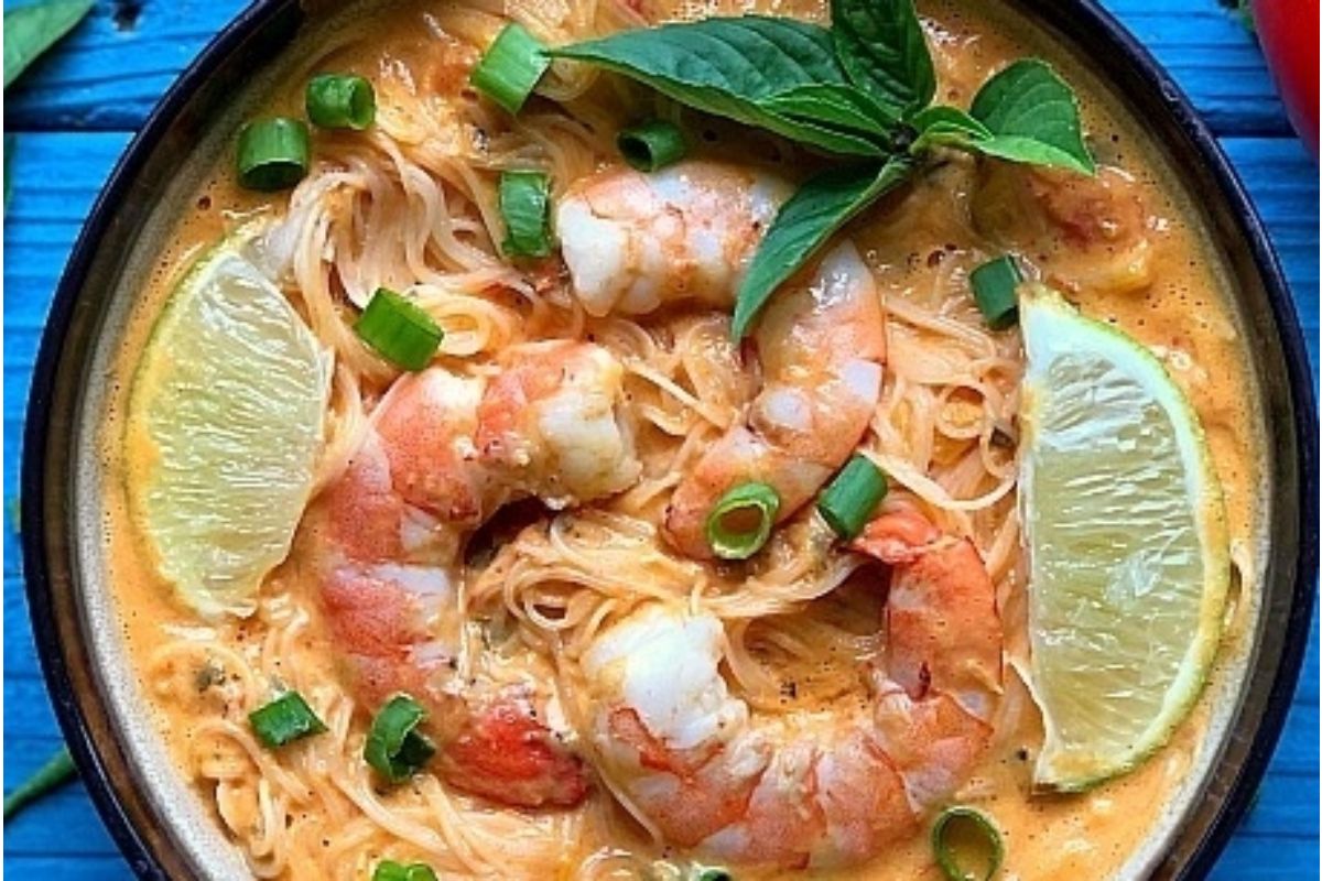 A bowl of Thai noodle soup with shrimp and lime, perfect for tomato based soup recipes.