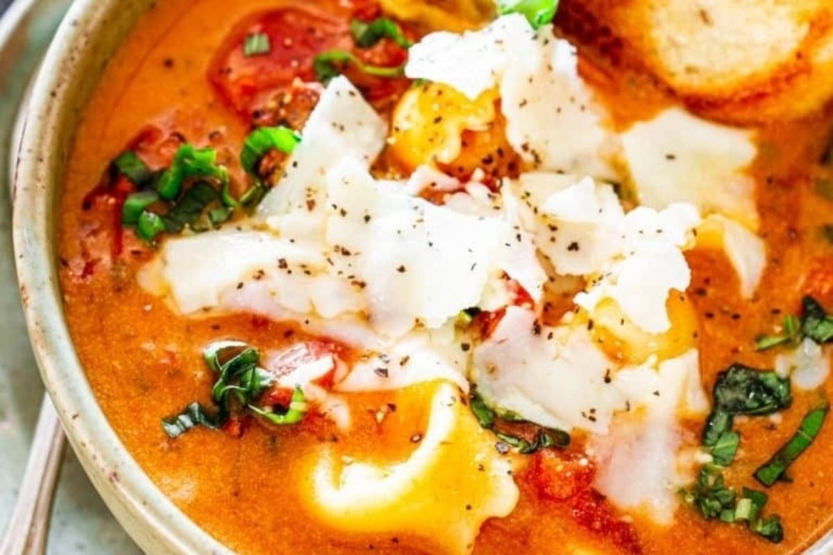 A tomato-based soup with cheese and basil.