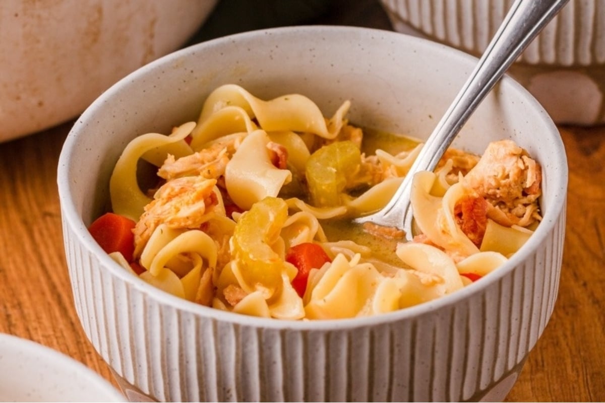 Make homemade chicken noodle soup in a bowl with a spoon using this simple chicken soup recipe.