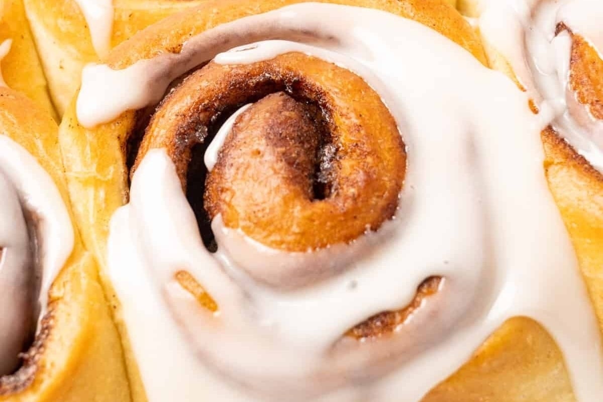 A close up of homemade cinnamon rolls with icing, made from the most delectable cinnamon roll recipe.