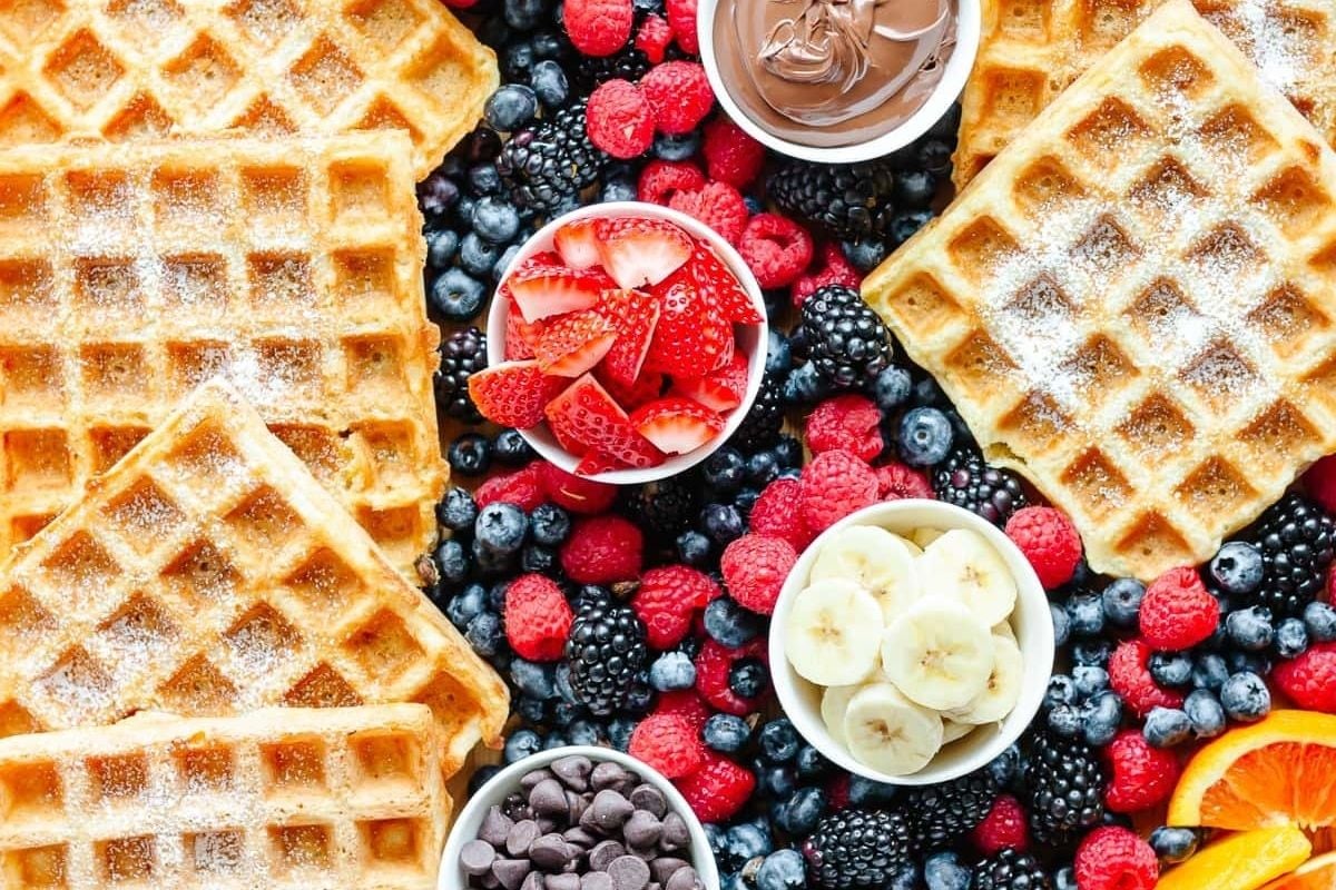         Description: Waffles with berries and bananas on a white background, perfect for waffle recipes.