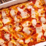 Ricotta beef stuffed shells in a white baking dish.