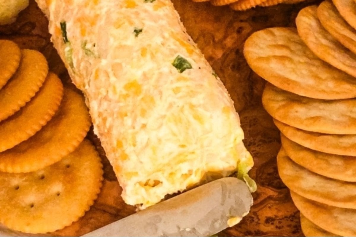 A plate with crackers and cheese on it for a girl's dinner.