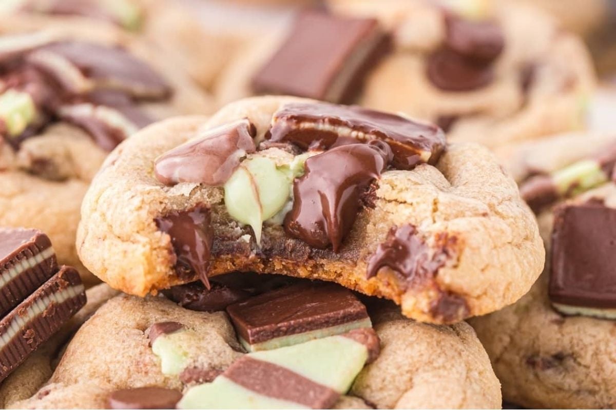 Indulge in these delicious chocolate mint cookies, showcasing a tempting bite taken out of them.