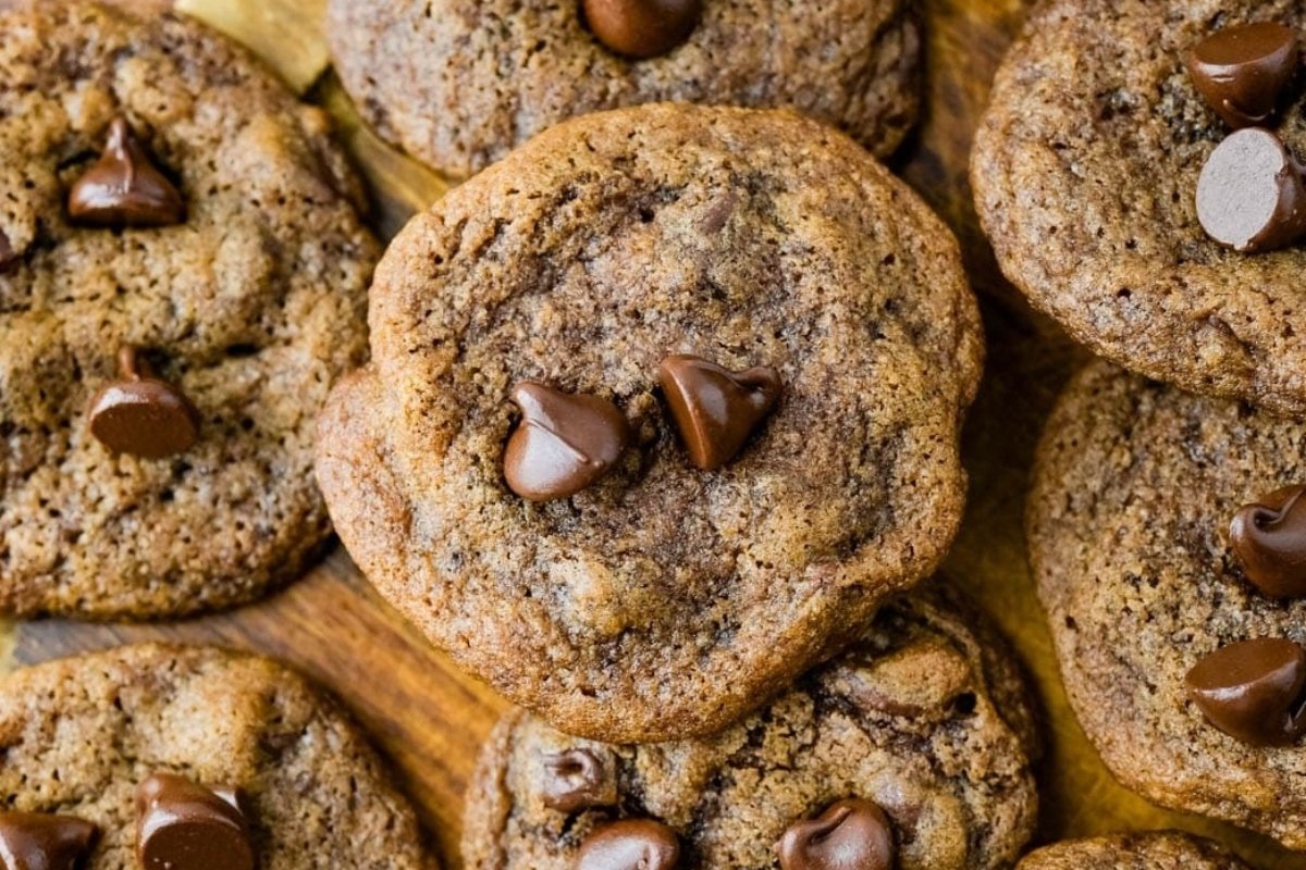 Chocolate chip cookies on a wooden cutting board, perfect as St. Patrick's sweets.