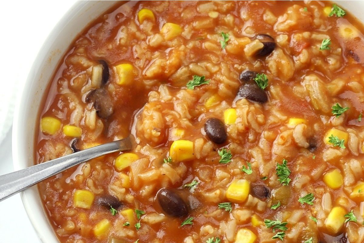 A bowl of taco flavored Mexican rice soup with black beans and corn.