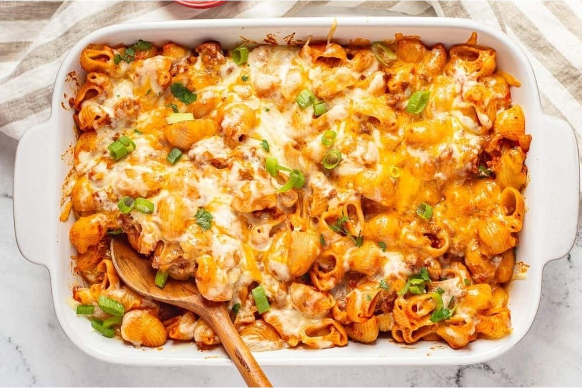 A casserole dish with taco flavored cheesy macaroni and cheese.