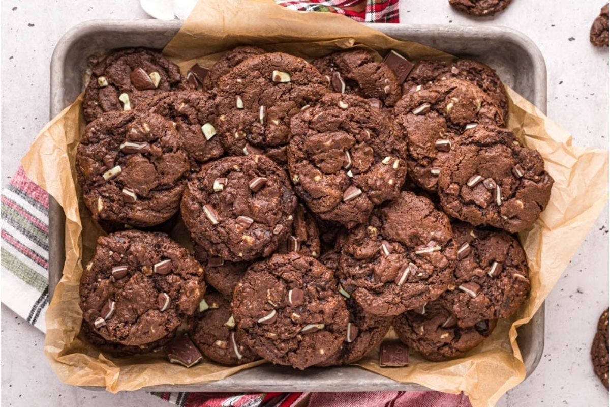 Chocolate cookies in a baking pan on a table.