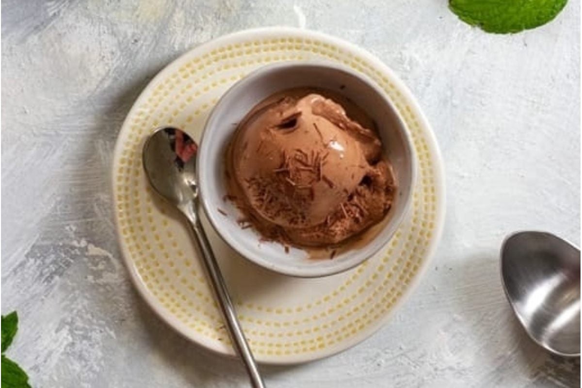 Indulge in a delicious bowl of chocolate ice cream garnished with fresh mint leaves.