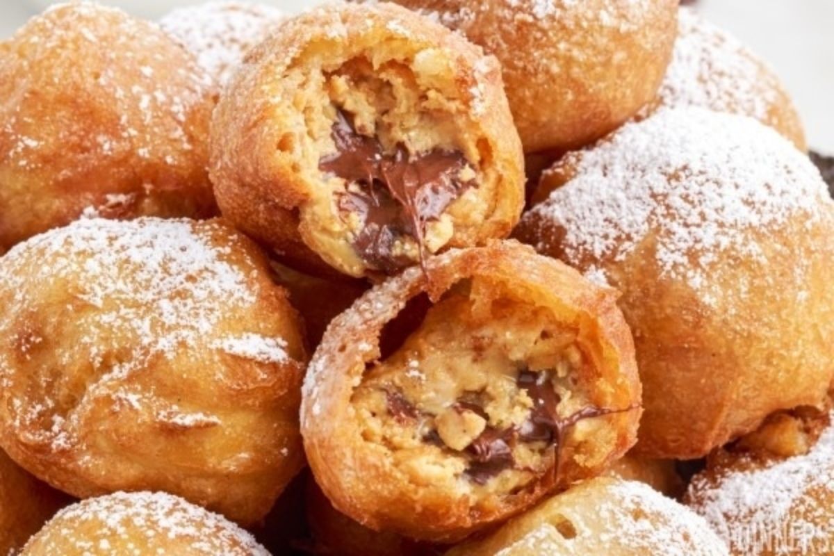 Chocolate peanut butter doughnuts with powdered sugar.