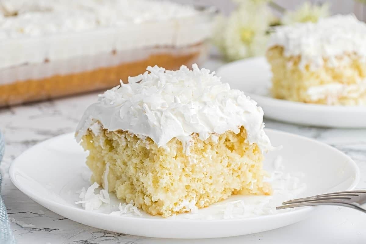 A slice of coconut cake with a fork is perfect for Cool Whip lovers.