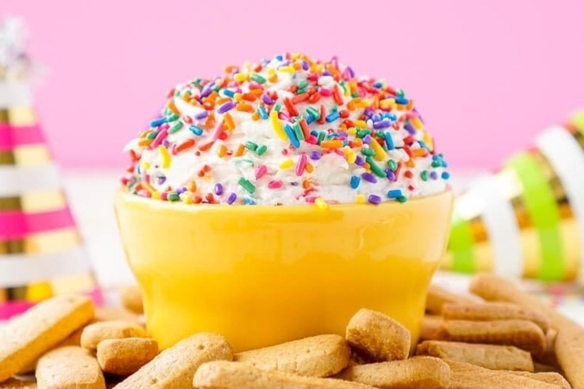 A bowl of ice cream with rainbow sprinkles.
