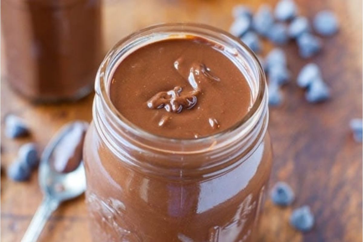 Chocolate peanut butter mousse in a jar with blueberries.