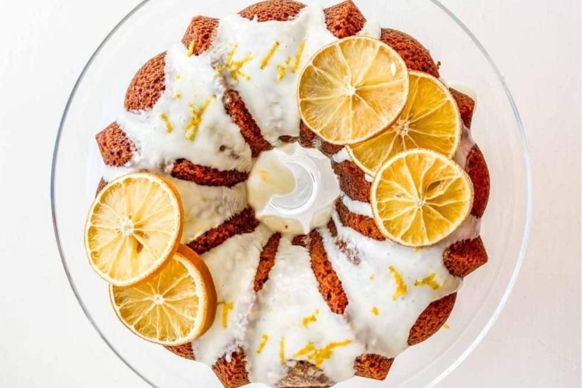 A citrus bundt cake topped with lemon slices.