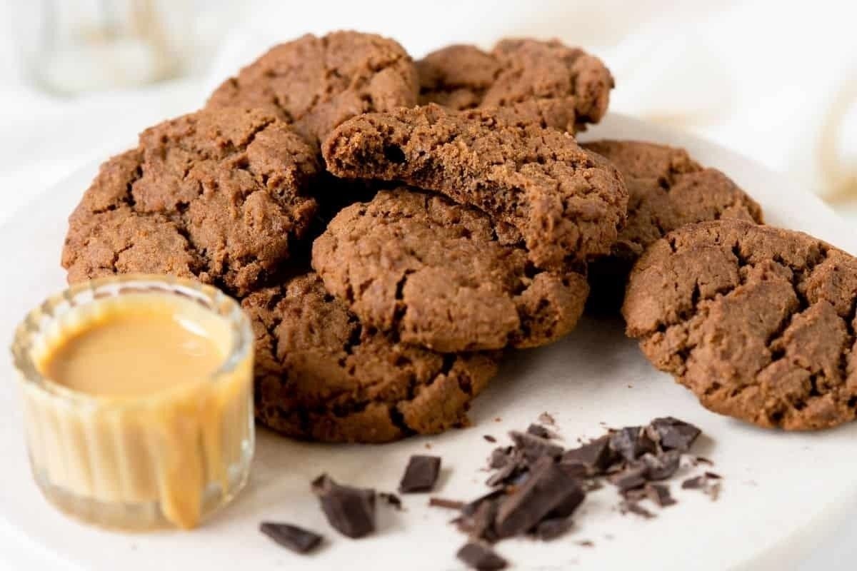 Chocolate peanut butter cookies on a white plate.