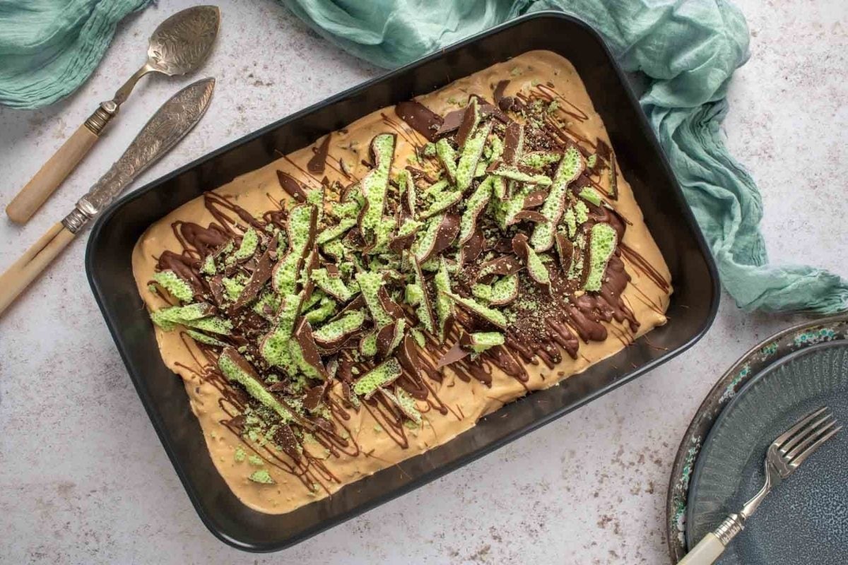 A baking dish with a pizza covered in toppings on it.