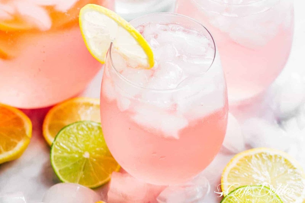 A pitcher of pink sangria with limes and lemons for St. Patrick's drinks.