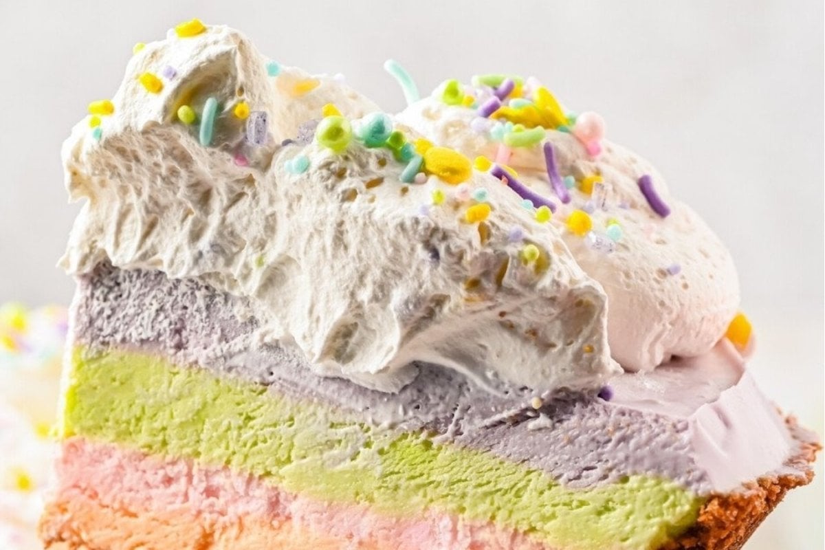 Indulge in this colorful slice of rainbow cake made from a unique recipe.