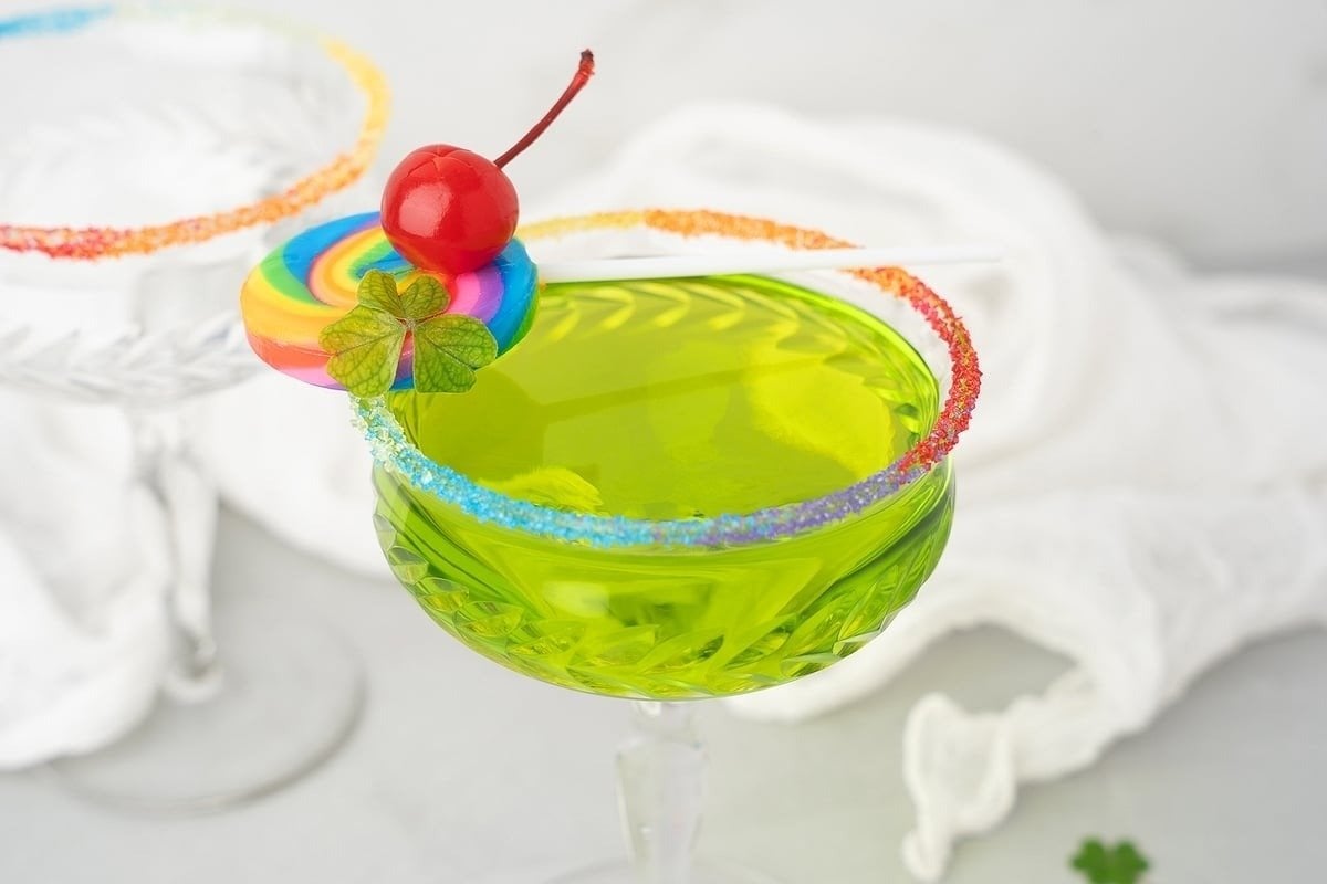 A green martini with a cherry on top.