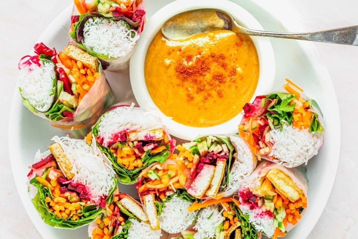 A plate of food with a bowl of soup, perfect for a rainbow-themed dinner party.