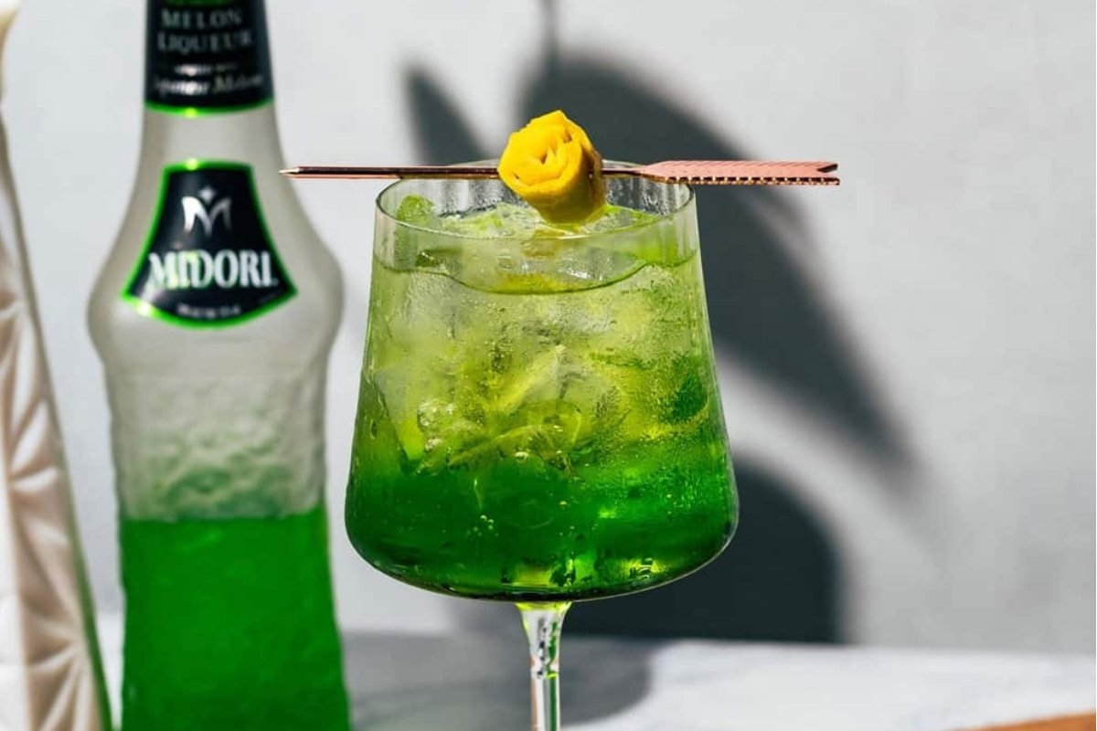 A green St Patrick's drink with a bottle next to it.