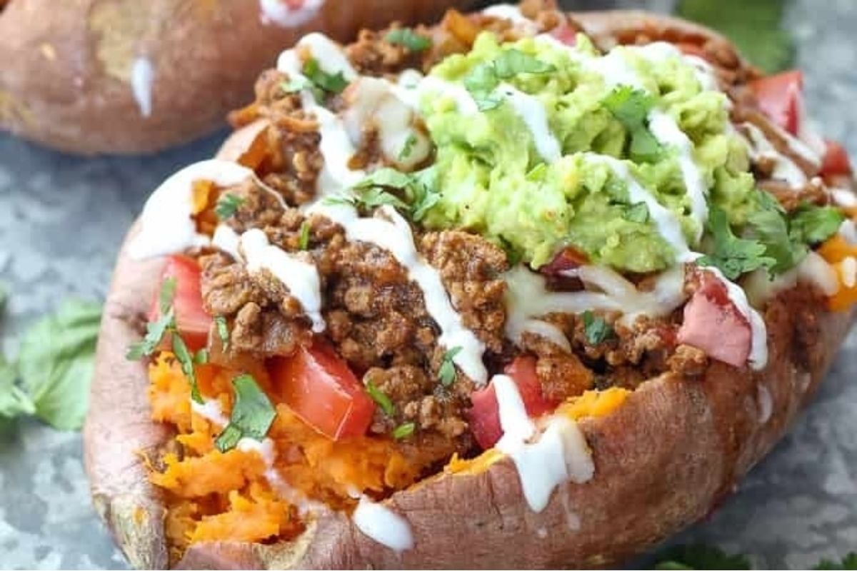 Stuffed sweet potatoes with taco flavored meat and guacamole.