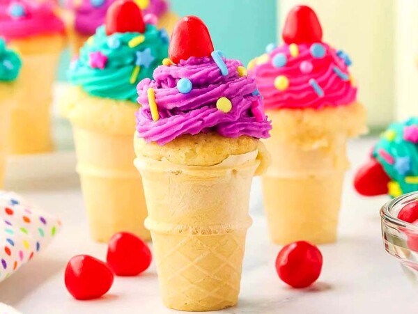Cupcake ice cream cones with colorful sprinkles and candy.