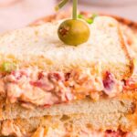 A sandwich with a pimento olive on top.