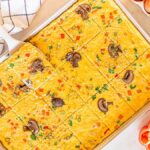 A tray of sheet pan eggs and vegetables cooked on a sheet pan.