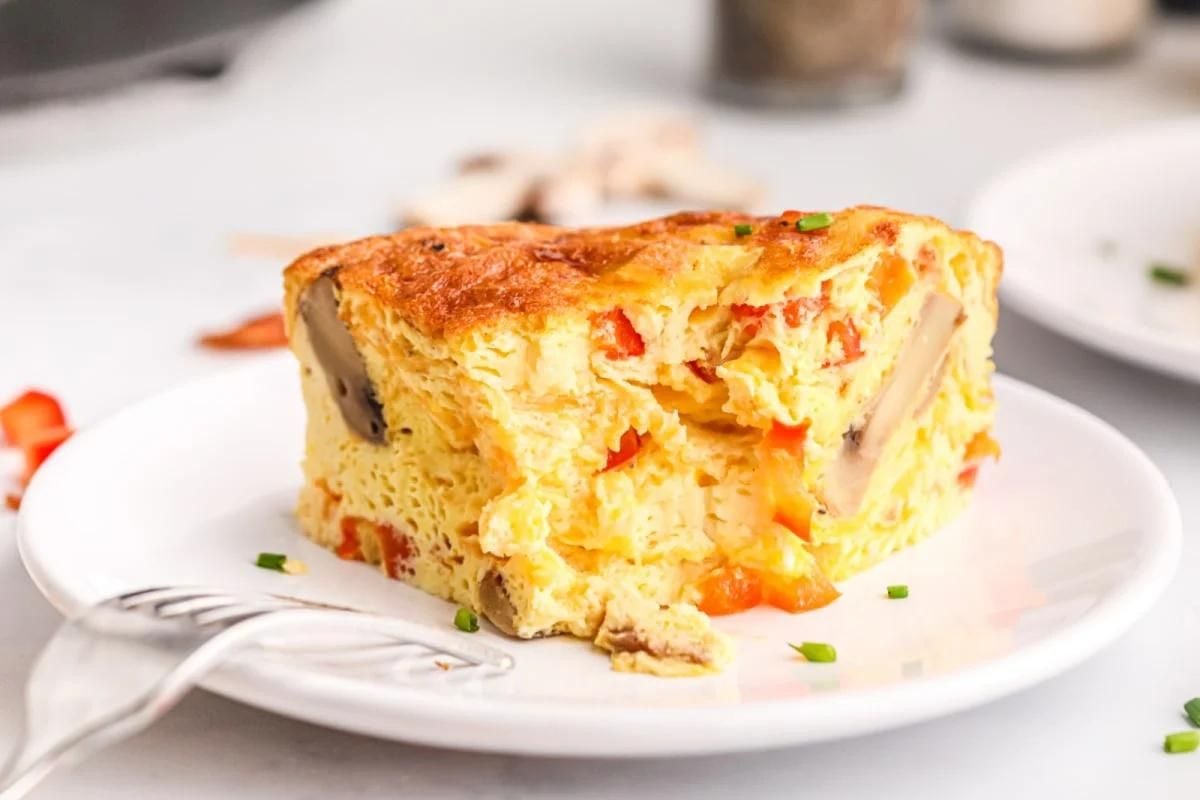 A slice of egg breakfast casserole on a plate.