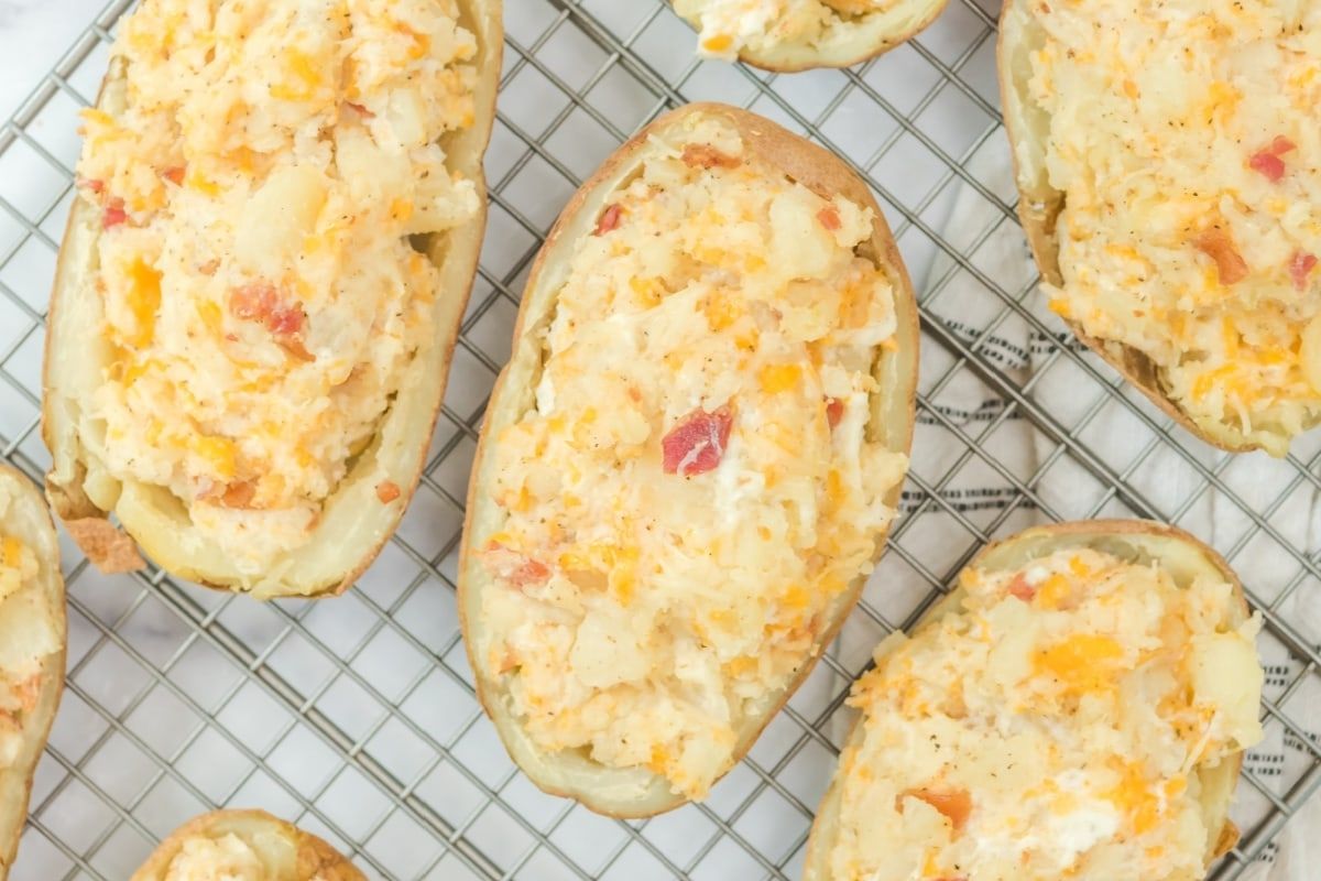 Cheesy recipes: Twice-baked potatoes topped with cheese and bacon on a cooling rack.