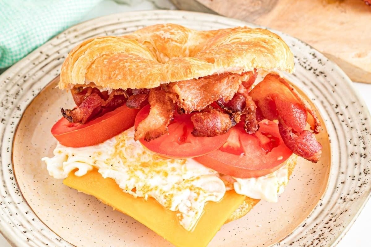 A bacon, egg, cheese, and tomato sandwich on a croissant for Father's Day breakfast.