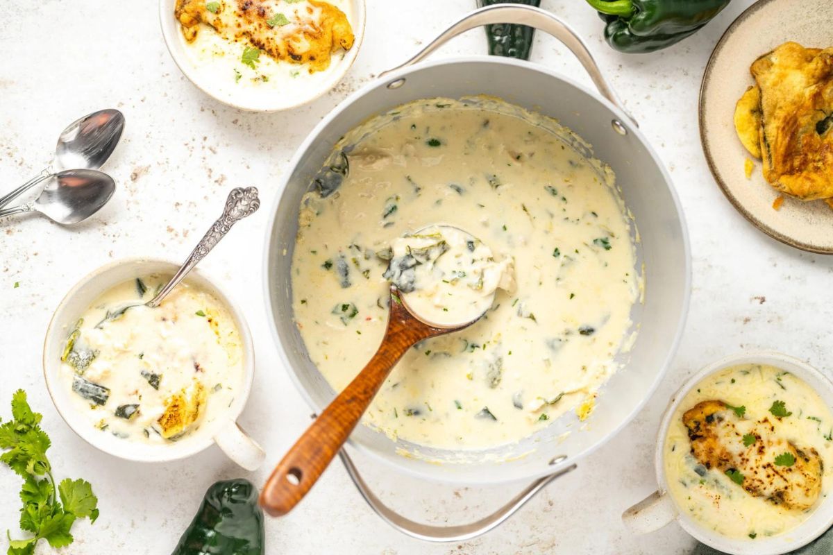 A pot with a spoon in it, perfect for trying out new soup recipes.