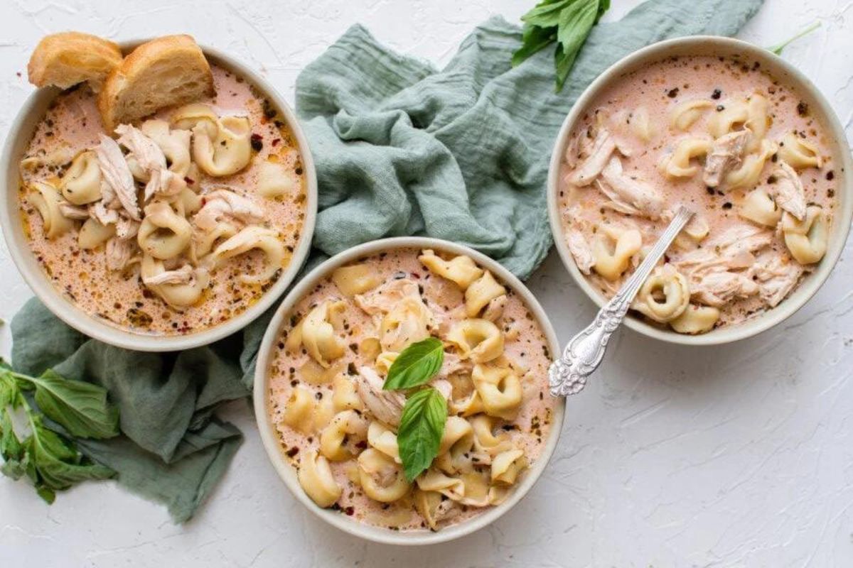 Bowls of soup recipes with tortellini and bread.