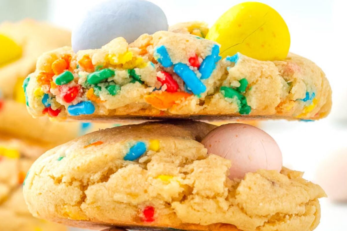 Colorful candy pieces embedded in a stack of freshly baked Easter cookies.