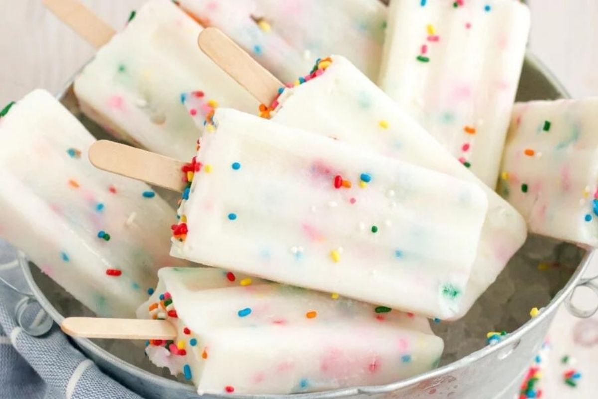 A tray of homemade popsicle recipes with colorful sprinkles inside.