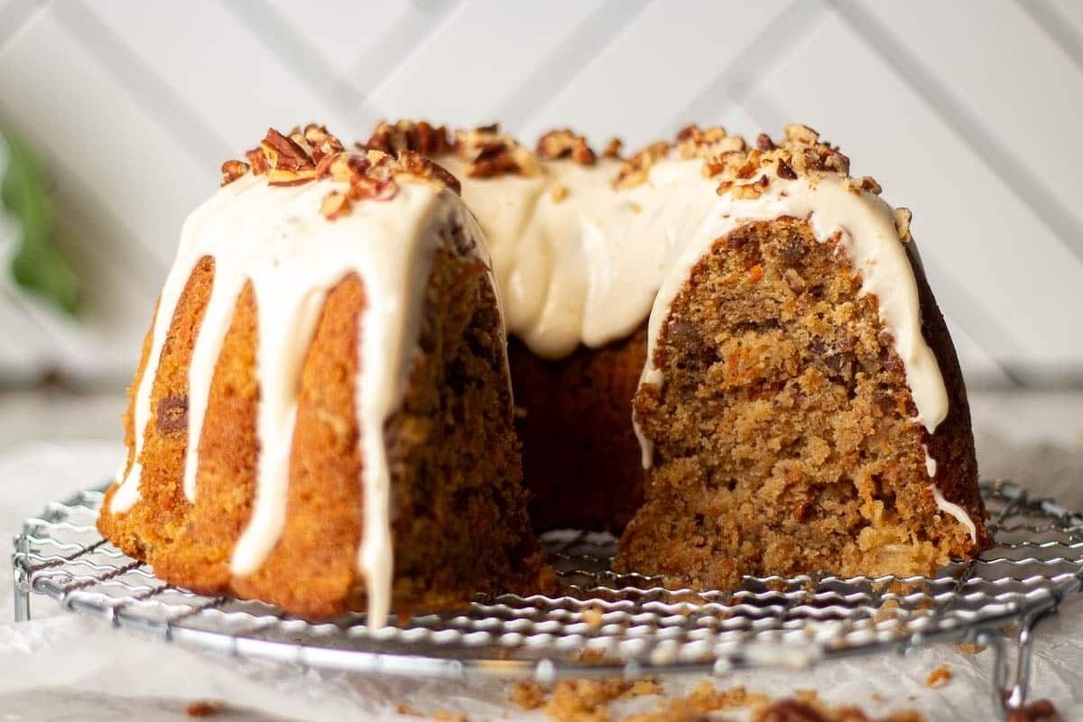 A bundt cake with icing on top, perfect for potluck desserts.