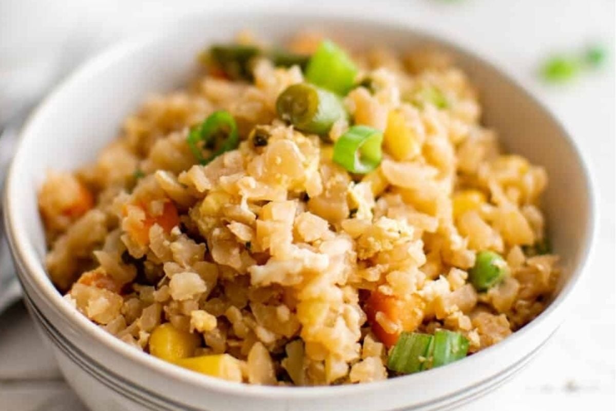 A bowl of fried rice with vegetables and peas, perfect for potluck sides.