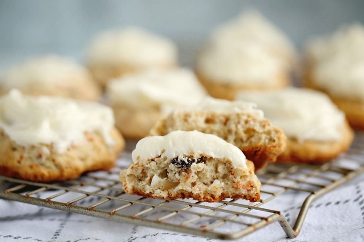 Freshly baked scones with cream topping, served on a cooling rack as featured in our latest Cookie Recipes.