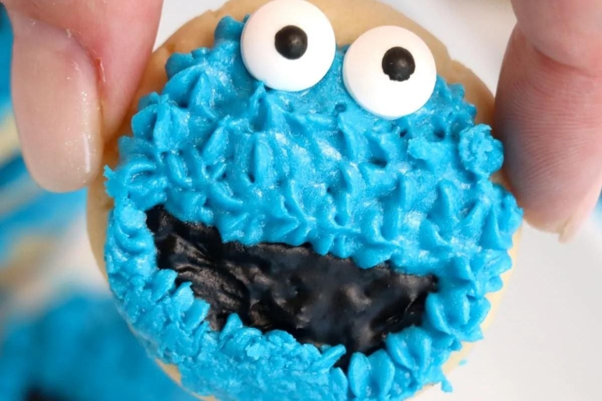 A cookie recipe designed to create a treat decorated with blue icing and candy eyes, perfectly mimicking the iconic Cookie Monster character.
