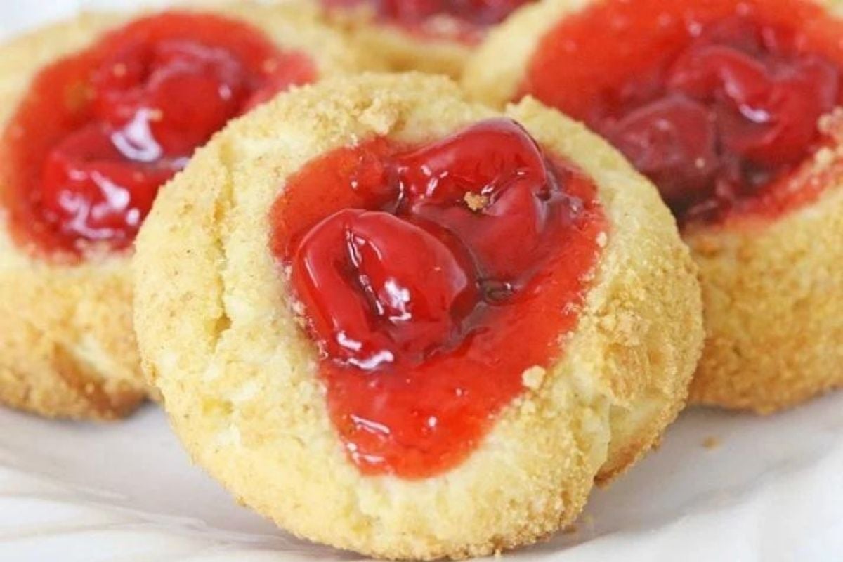 Plate of thumbprint cookie recipes with red jam centers.