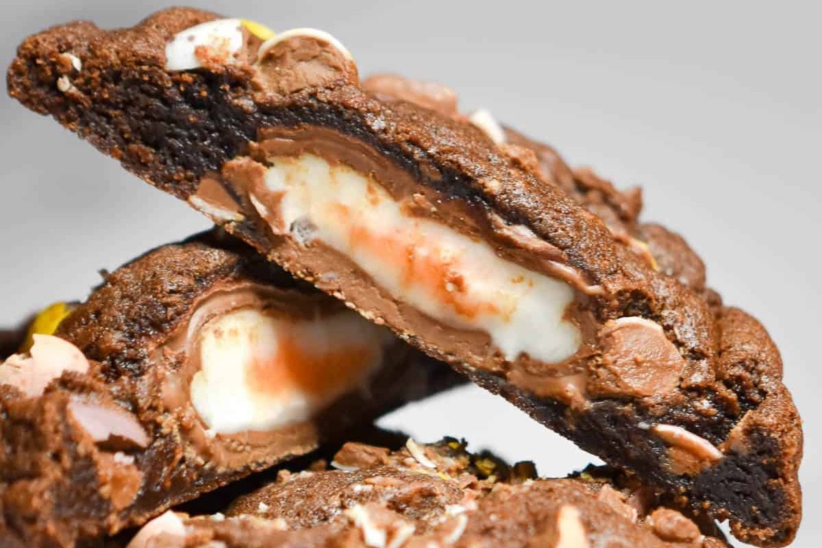 Close-up of an Easter cookie with melted white and dark chocolate chips and a gooey marshmallow center.