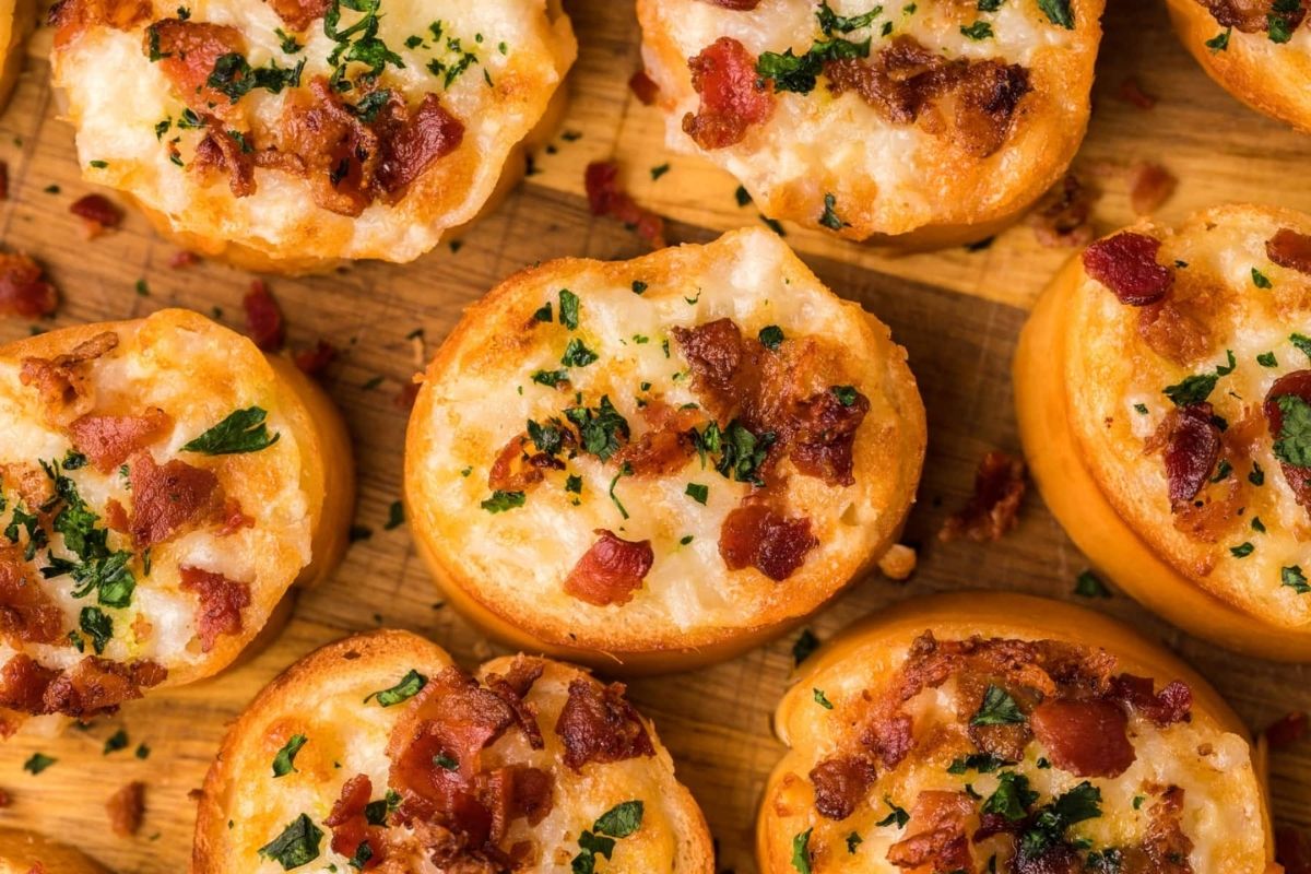 Cheesy recipes for bite-sized appetizers topped with melted cheese, bacon bits, and a sprinkle of herbs.