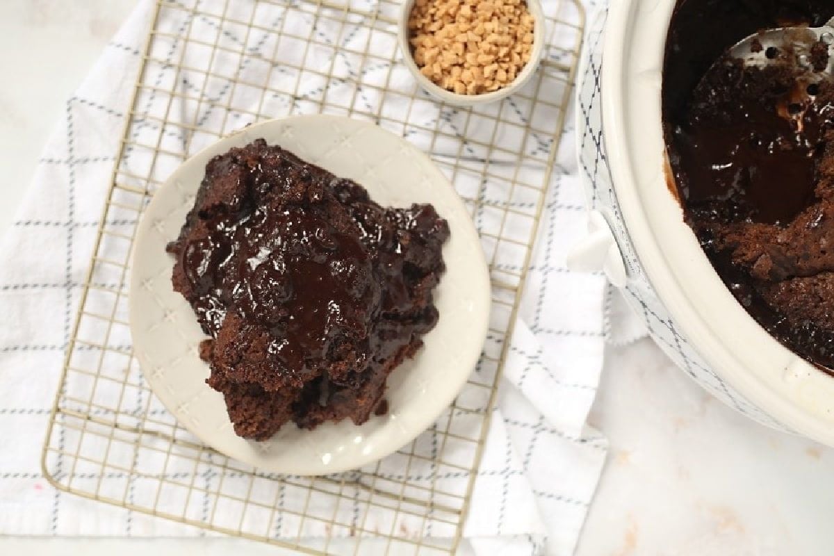 A slow cooker full of brownies on a plate.