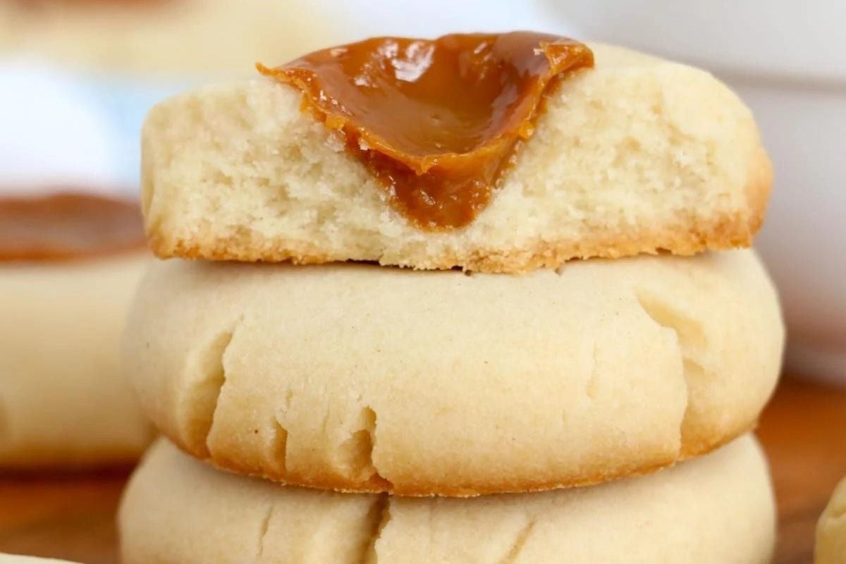 Alfajor cookie recipes with dulce de leche filling on top of another alfajor.
