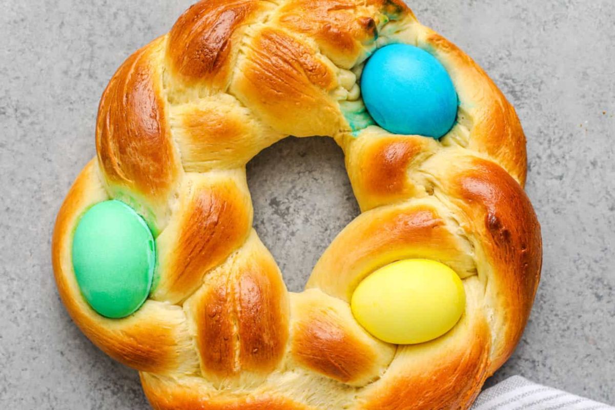 Easter treats for kids: Easter bread wreath with three pastel-colored eggs baked into the dough.