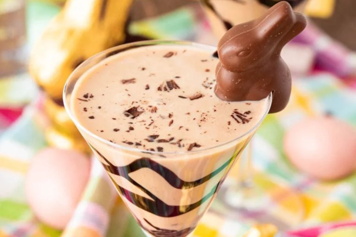 Chocolate milkshake with a chocolate bunny garnish served in a glass with chocolate syrup, perfect for Easter cocktails.